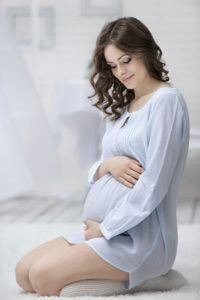 pregnant woman holding belly