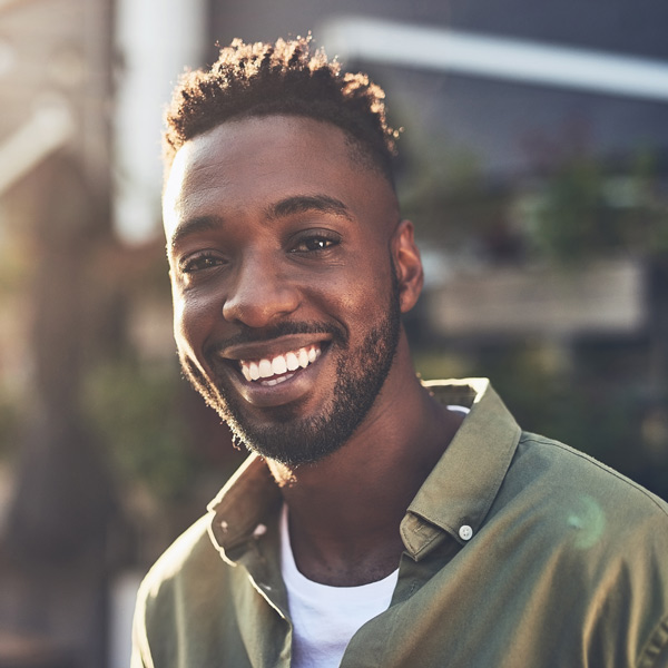 man smiling in green shirt